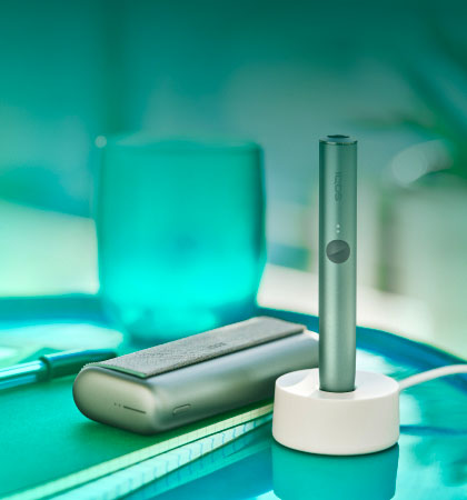 A jade green IQOS ILUMA PRIME Pocket Charger and Holder.